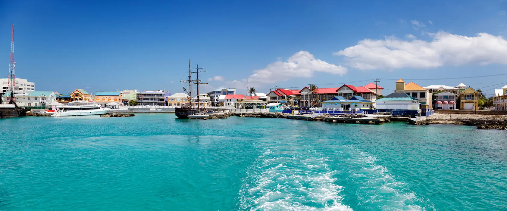 View of George Town harbor with colorful buildings and calm turquoise waters