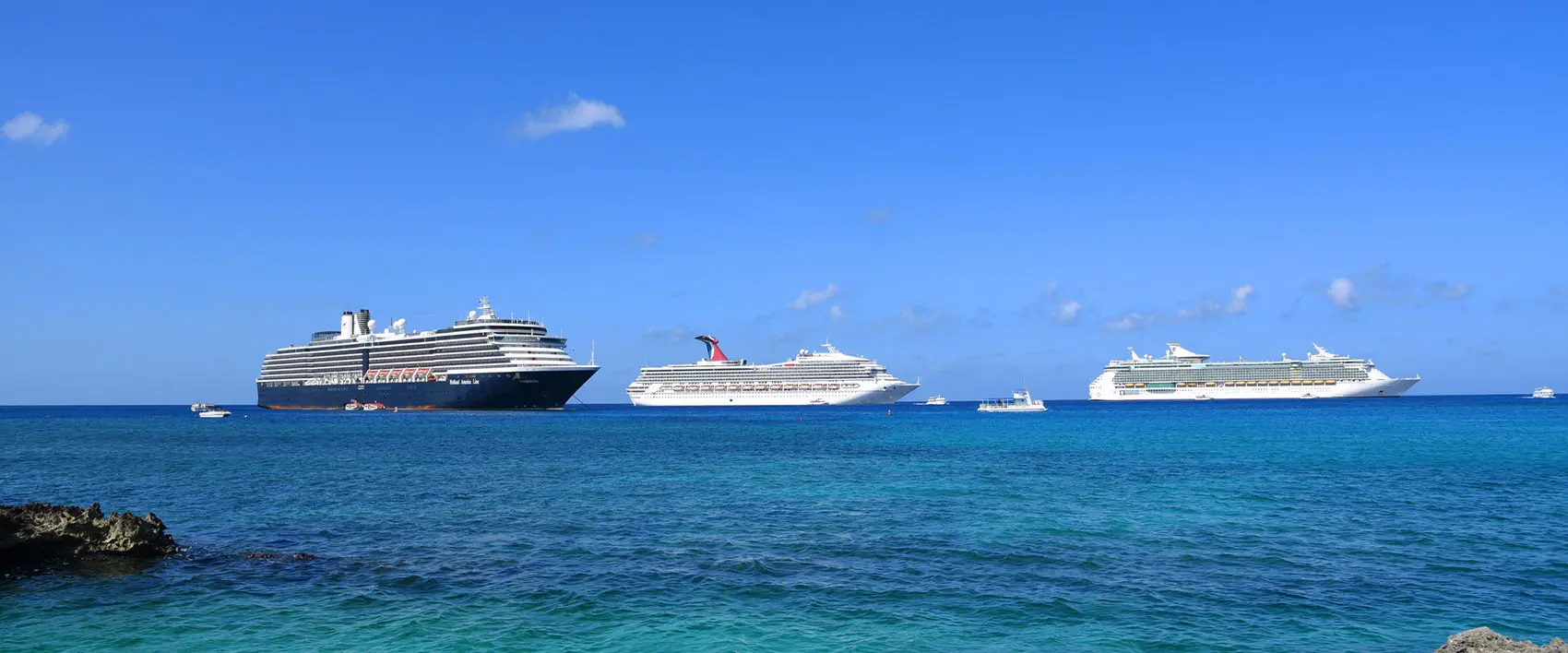 Cruise ships anchored near the coast of the Cayman Islands.